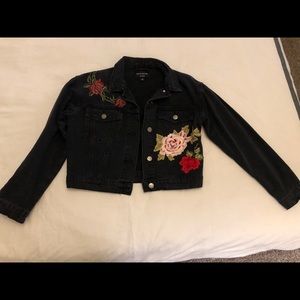 Floral embroidered black denim jacket.